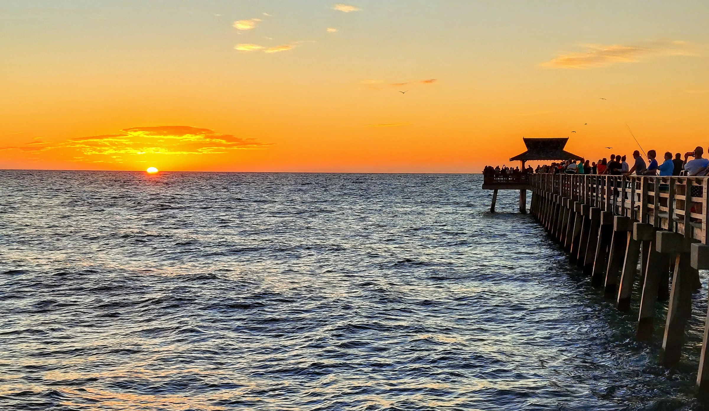 Sunset over the beach and pier in Naples, Florida